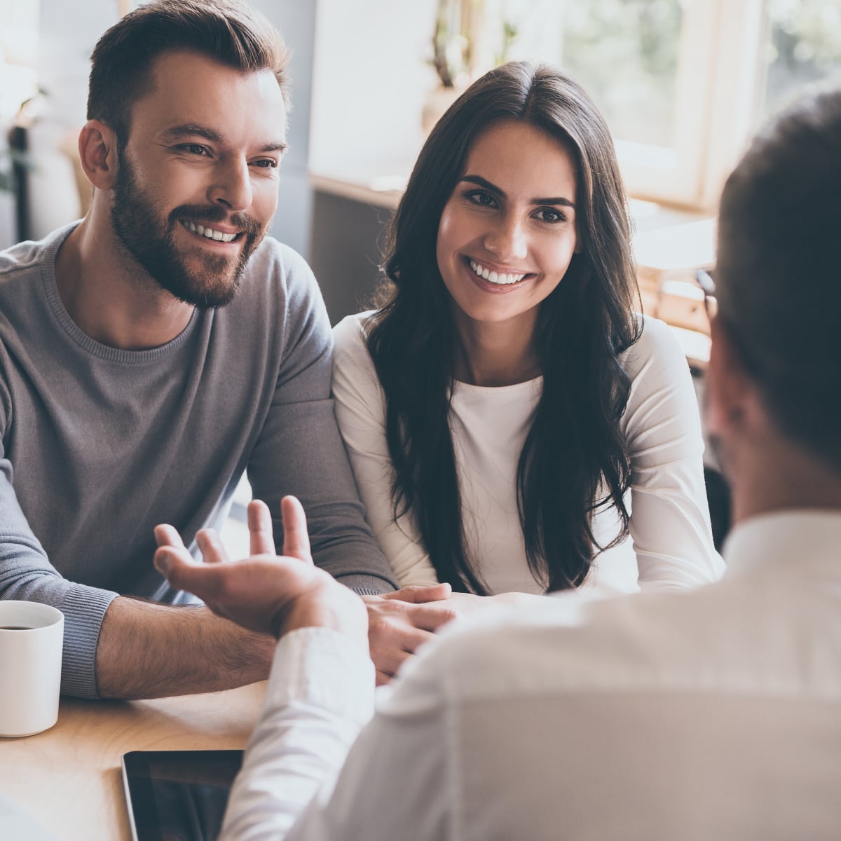 couple smiling at a meeting with a financial advisor
